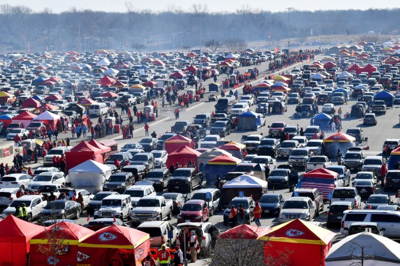 A packed Kansas City tailgate lot filled with tents and fans